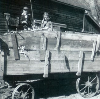 #168=Elliott&Candi in corn wagon; Oct. 1961