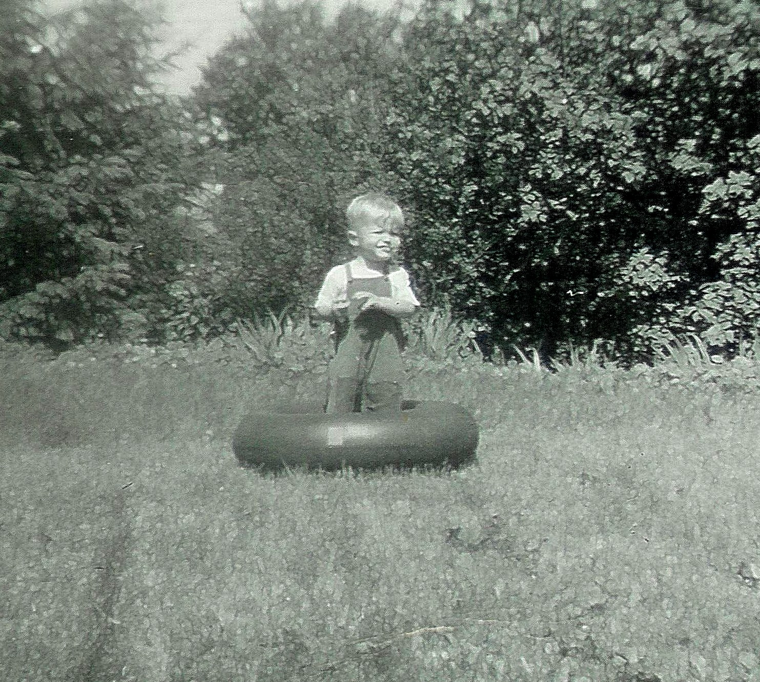 #150=Elliott in innertube in front yard, circa 1957