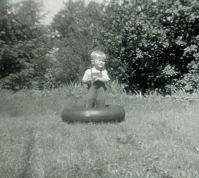 #150=Elliott in innertube in front yard, circa 1957