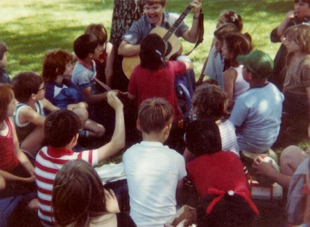 #209=Elliott singin' outside with kids; Spring 1983