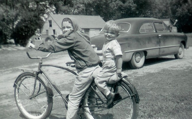 #79=Elliott & Rosemary on bike near blue '49 Ford